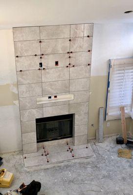 Living room tile being installed.  The polished look doesn't show in the pictures.