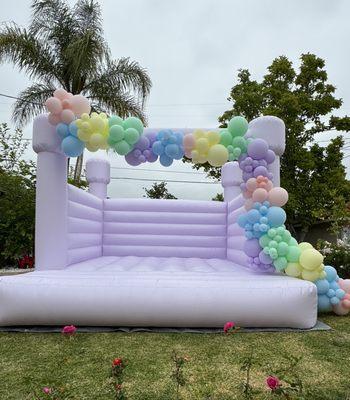 Lavender Bounce House with balloon garland