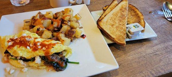 Med Omelet with feta, spinach, schrooms and feta doused with Cholula. SD toast well done and breakfast potatoes: fresh tasting.