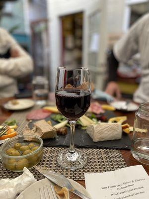 Cheese and Charcuterie Tray with 3 Cheese and 3 Meat and glass of Santa Cruz Grenache