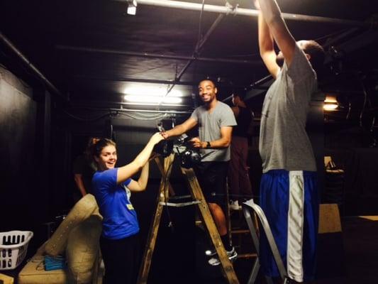 Second Year Students helping with light hang for their showcase production.