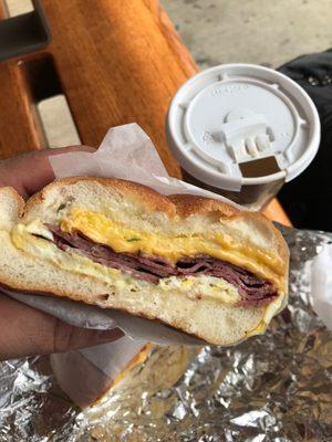 Bomb Pastrami, egg & cheddar on a roll + cafe con leche (done up RIGHT for that light and sweet awesomeness). Cheap and good!