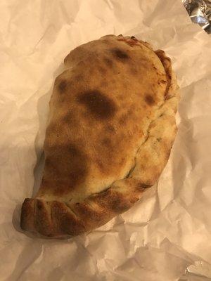 Meat feast calzone, about a foot long