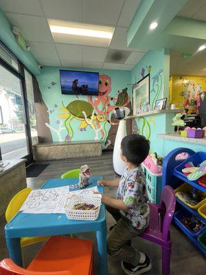 Playful waiting area with toys, activity table, tv & Robin the robot!