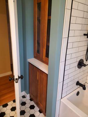 Reconfigure bathroom back to original with custom cabinets, tile work, wainscoting and new soaker tub