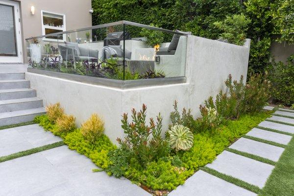 Elevated seating area with BBQ and fire table.