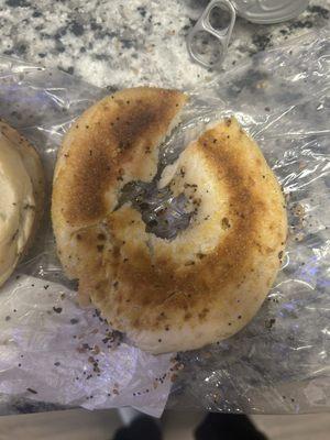 Paper thin half of bagel that is so thin it crumbles.  All 3 bags we bought were like this.  How hard is it to cut a bagel?