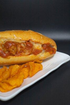 Meatball & cheese sandwich with a side of chips