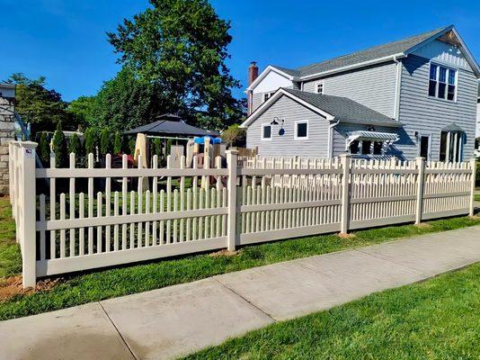 48" high tan PVC double row Saturn-style with straight pickets we fabricated and installed in East Meadow, NY.