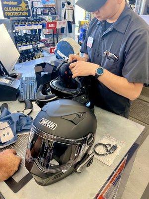 Damien installing Sena Bluetooth Systems in our helmets