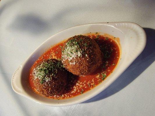 Arrancini Siciliano: Risotto fritters stuffed with Gorgonzola cheese atop Livornese sauce.