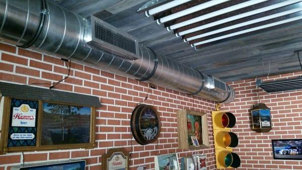 Exposed spiral duct with side mount registers in garage at pacific palisades.