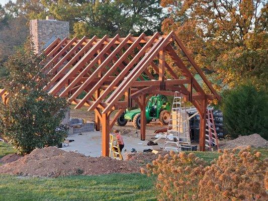 Custom timber frame pavilion and large wood burning fireplace under construciton.