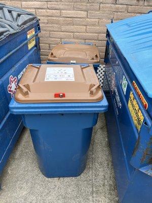 Who's idea was it to put two food waste containers between the two dumpsters, so you can not get to the dumpster???