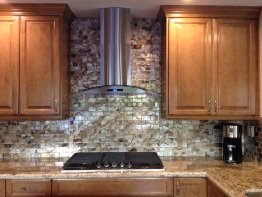 Amazon Stones- Netuno Bordeaux granite slab (with Elida Volcanic Essence mosaic glass tile backsplash)