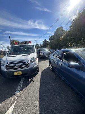 Double parked and causing cars to have to go around the solid lines.