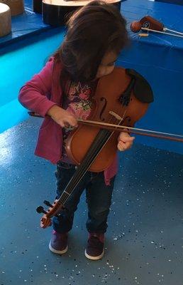 Violin first-timer.  During an open house, she picked up a violin from the "musical petting zoo"