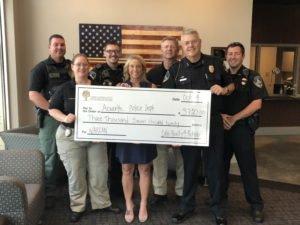 Presenting Acworth Police Department with dollars raised by Cobb Community Squared to purchase NARCAN