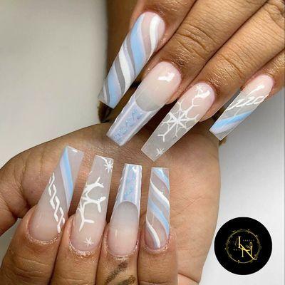 Get into the winter spirit with stunning nail art!  
From icy blues to snowflakes accents, your nails will sparkle all season long.