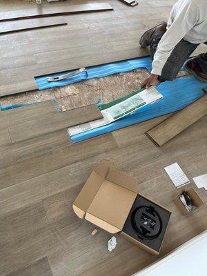 Cardboard was used under improperly installed flooring.