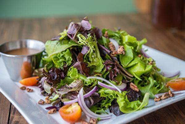 House salad with fresh spring mix, tomatoes, red onions, candied pecans and your choice of dressing.