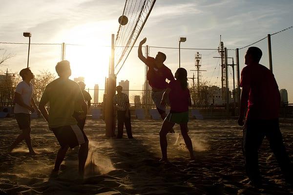 Who wouldn't love a gorgeous sunset with your feet in the sand for beach volleyball?