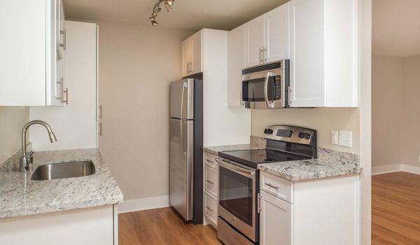 Modern kitchen with stainless steel appliances and granite countertops