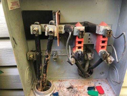 BEFORE ---- Replacing burned interior of meter socket.