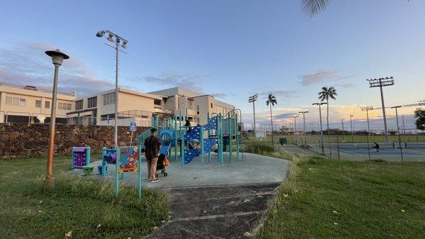 Here the playground w/ pool & rec behind along with the courts