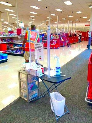 Sanitizing station at the entrance with hand sanitizer and masks