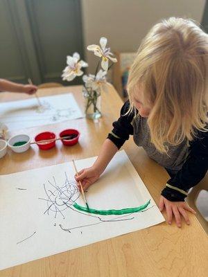 Child growing developmentally through tactile, creative learning with environmental resources