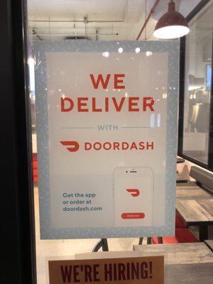 We deliver with door dash sign