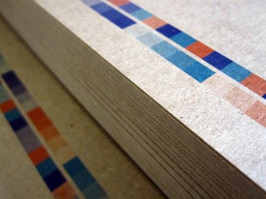 We print a lot on chipboard, a 100% recycled, heavy weight paper stock. It's  great for postcards, business cards and more!