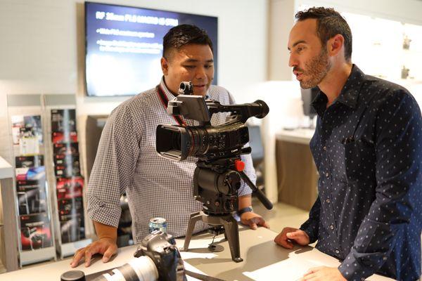 Canon Senior Trainer Charles Zablan (left) sharing tips and tricks of different Canon cameras to a film industry professional.