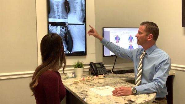 Dr. Matthew Davis going over diagnostic digital xrays and computerized scans.