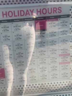 Holiday hours posted on the store window