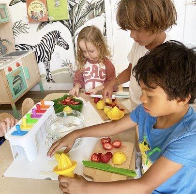 Kids have fun making their own strawberry lemonade popsicles!