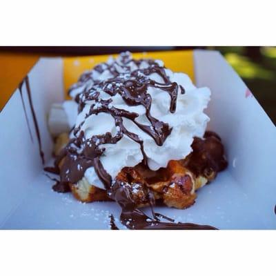 Amazing waffle strawberry banana whipped cream and chocolate syrup