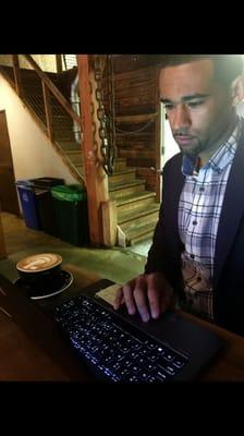 Agent Victor Bull at a local San Francisco coffee shop preparing to meet with a customer.