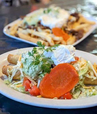 Chicken flautas con todo, carne asada fries in the background.