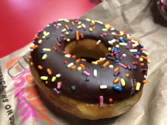 Chocolate frosted donut with sprinkles (2), side view. (1/10/2019)