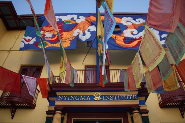 Nyingma Institute with prayer flag installation and Year of the Dragon Banner flying for the 40th Anniversary Party.