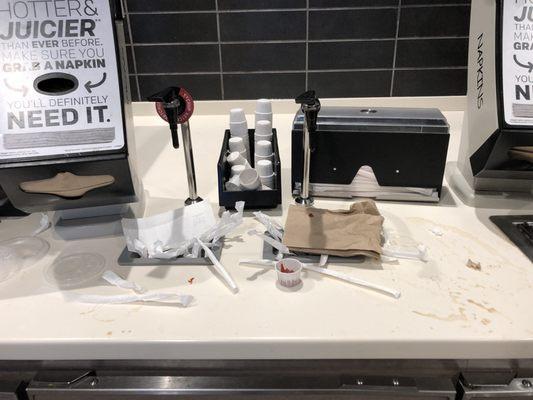 Trash overflowing (bathroom floors were similar), spilled drinks and ketchup all over counters.