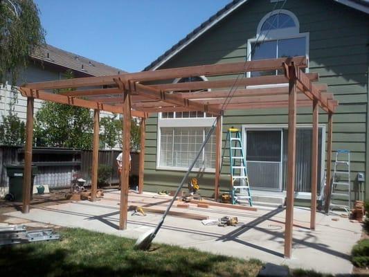 New Redwood Trellis Build, siding & trim repair along with a full exterior repaint.