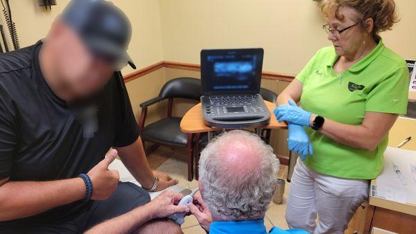 Conrad Tamea, MD, Board-Certified Orthopedic Surgeon using ultrasonography to diagnose and perform a knee procedure.