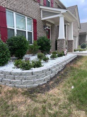 Stone border, fresh landscaping gravel and shrub install