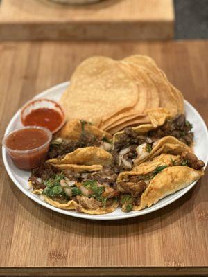 Carne Asada Tacos and Tortilla Chips with medium and spicy salsas