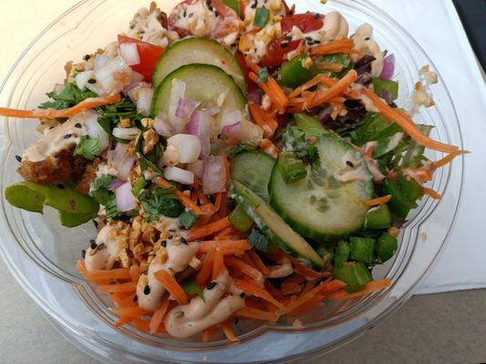 Tuna poke bowl with spring mix base, two servings tuna poke, red onion, jalapeno, cucumber, cilantro, carrot and tomato.