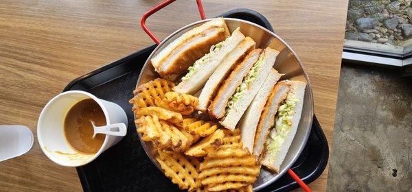 Pork sandwich with waffles fries and curry dip