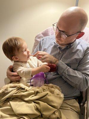 Sometimes brushing a little one's teeth takes patience! Nice daddy daughter time!